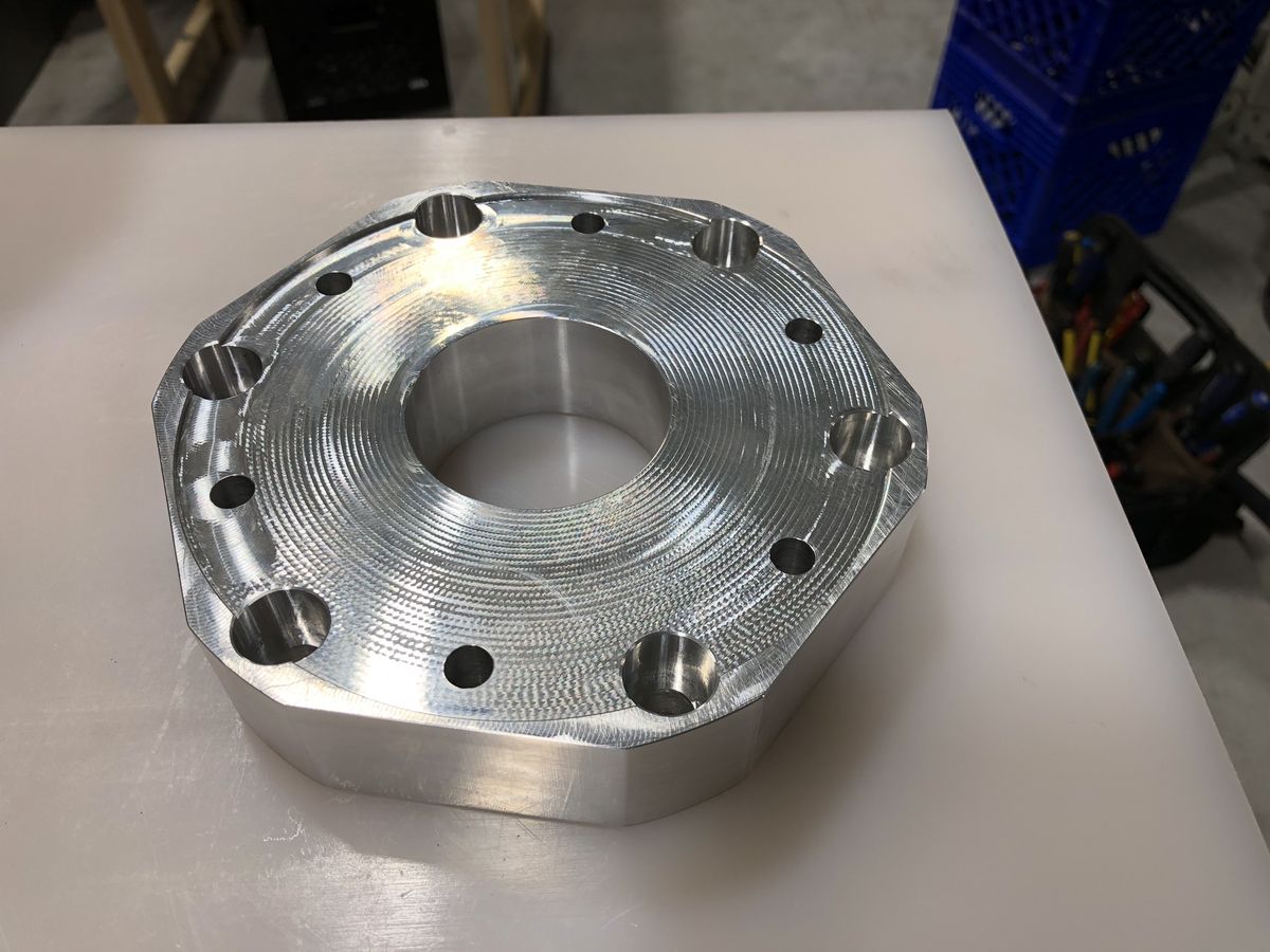 CNC machined flange with visible toolpath finish by Rigid Concepts